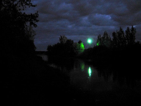 Light illuminates a small channel just off of the bike trail behind Michigan Steel in Muskegon, Michigan