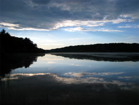 Rain clouds and their reflections frame the eastern shore of Muskegon County's Duck Lake on June 22, 2008