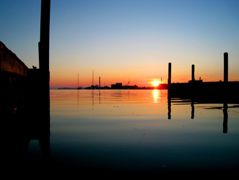 The boat docks at the Hartshorn launch frame the sunrise over Muskegon on June 23, 2008