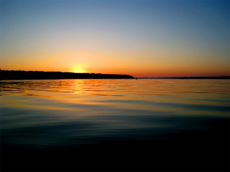The summer solstice sun rises over Muskegon County\'s White Lake on June 20, 2008