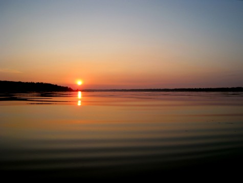 The sun rises over Muskegon County's White Lake on August 1, 2008